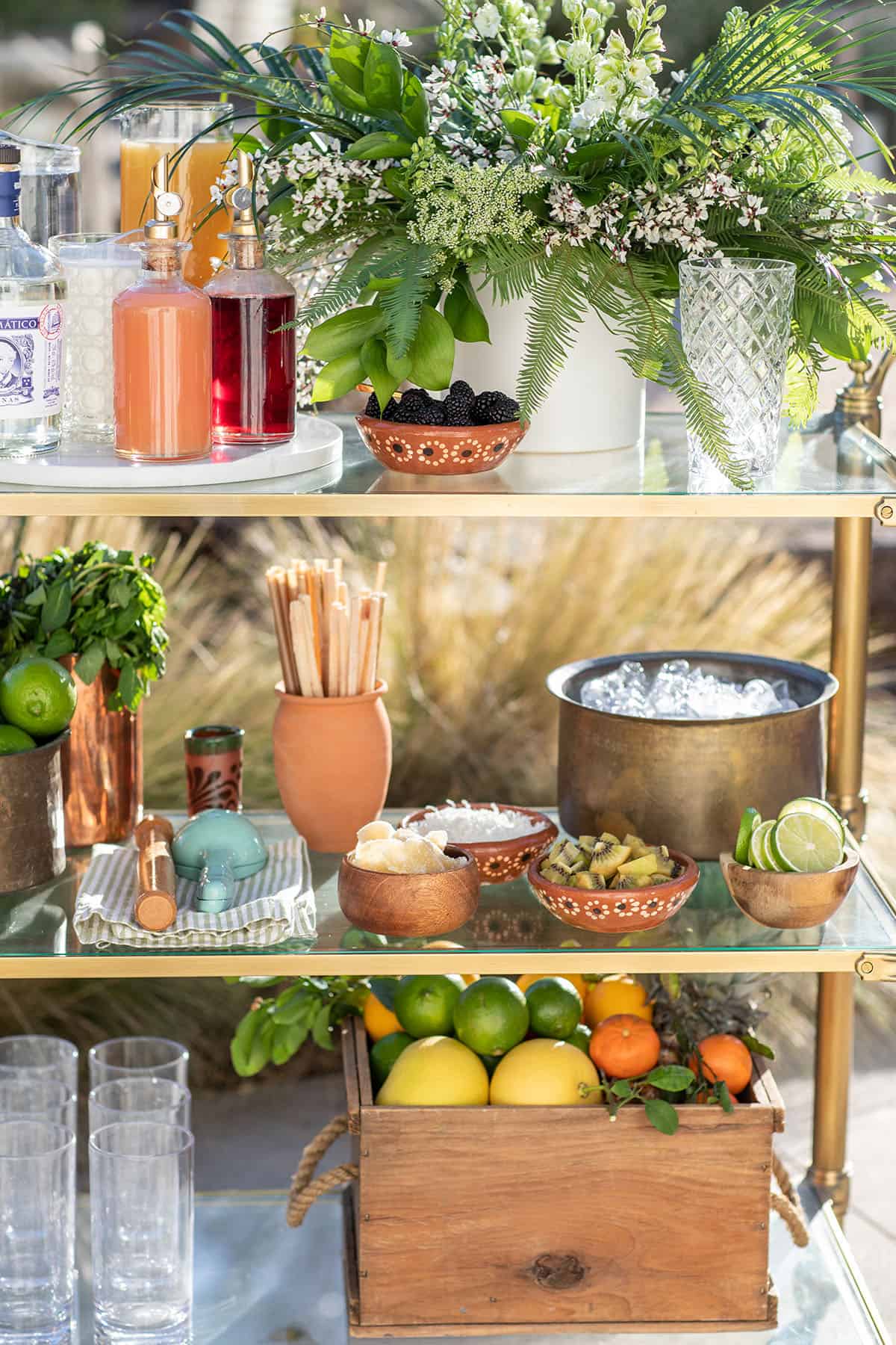 supplies for a mojito bar on a gold bar cart