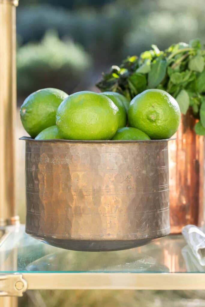 Limes in a copper bowl. 