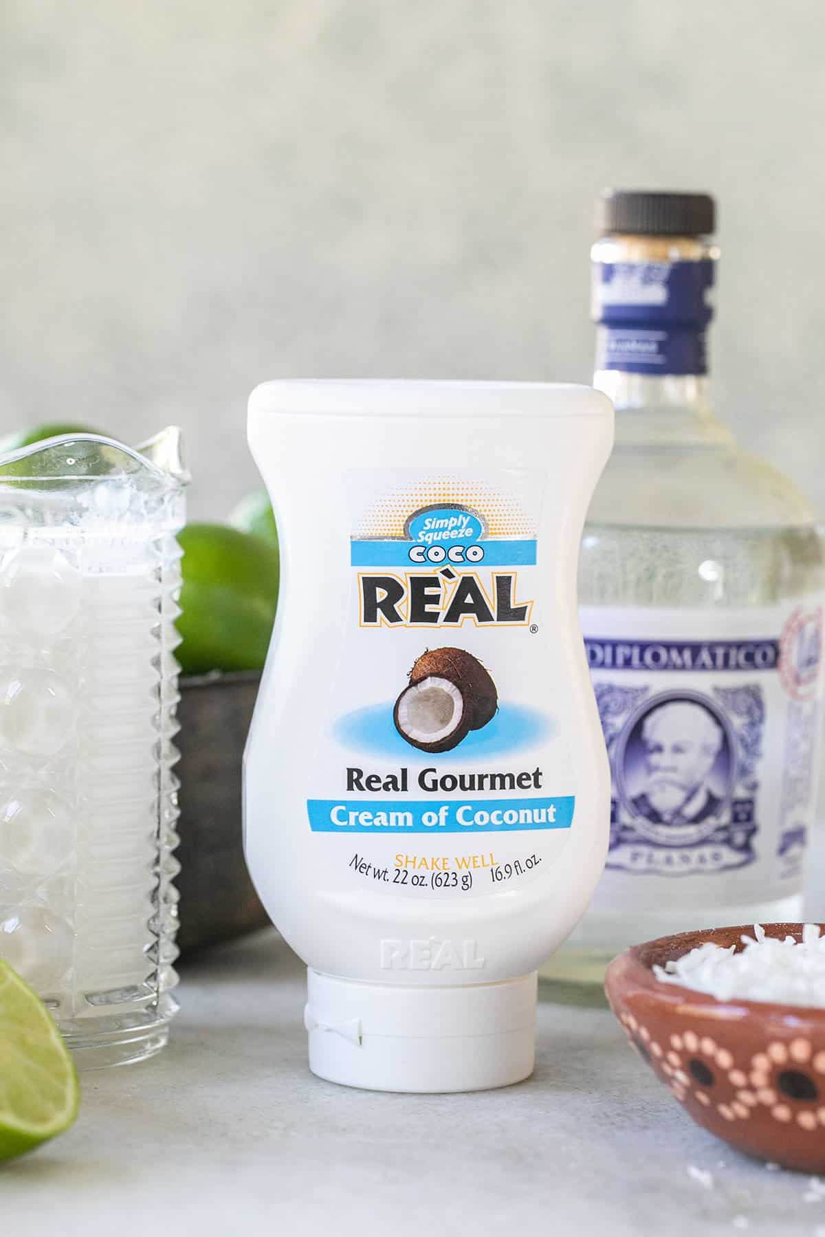 Real coconut cream on a table with rum and lime.