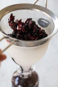 straining dried hibiscus syrup