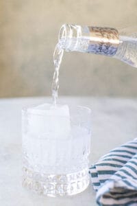 pouring tonic water over ice