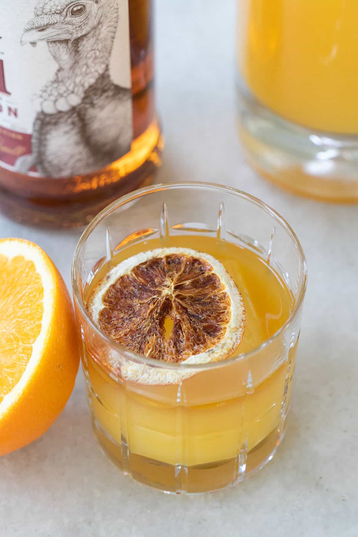 Whiskey and orange juice with an orange slice.