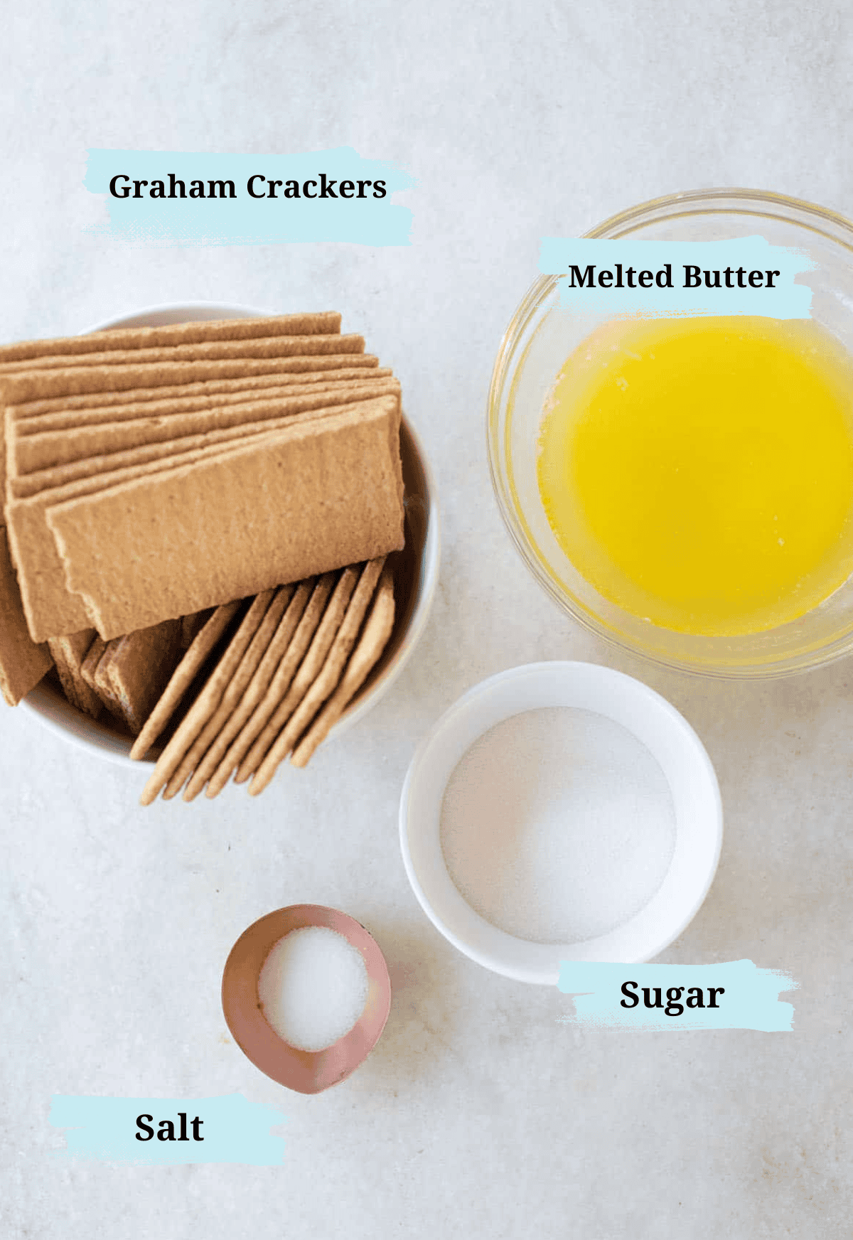 Graham cracker crust ingredients in bowls. 