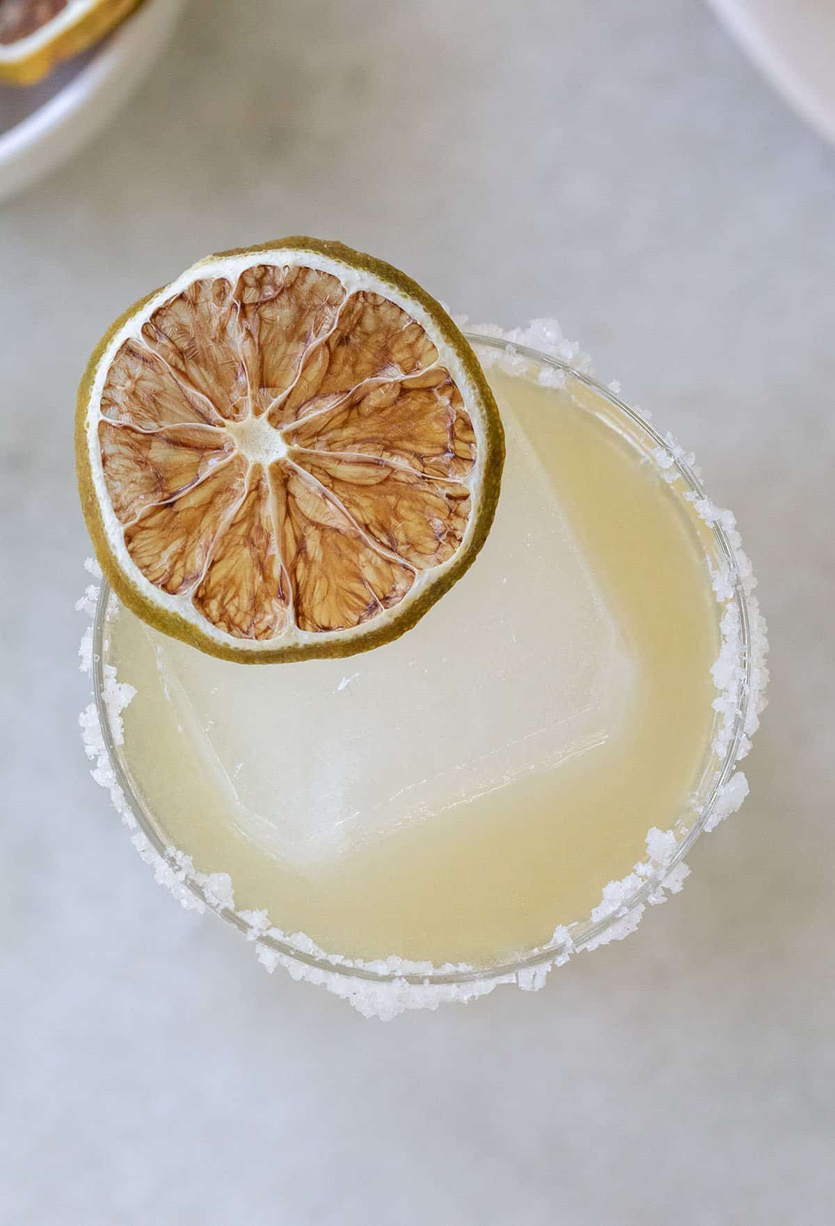 margarita recipe with gold tequila and garnished with a lime slice.