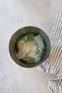 cocktail shaker filled with ice and ingredients to make a grasshopper drink