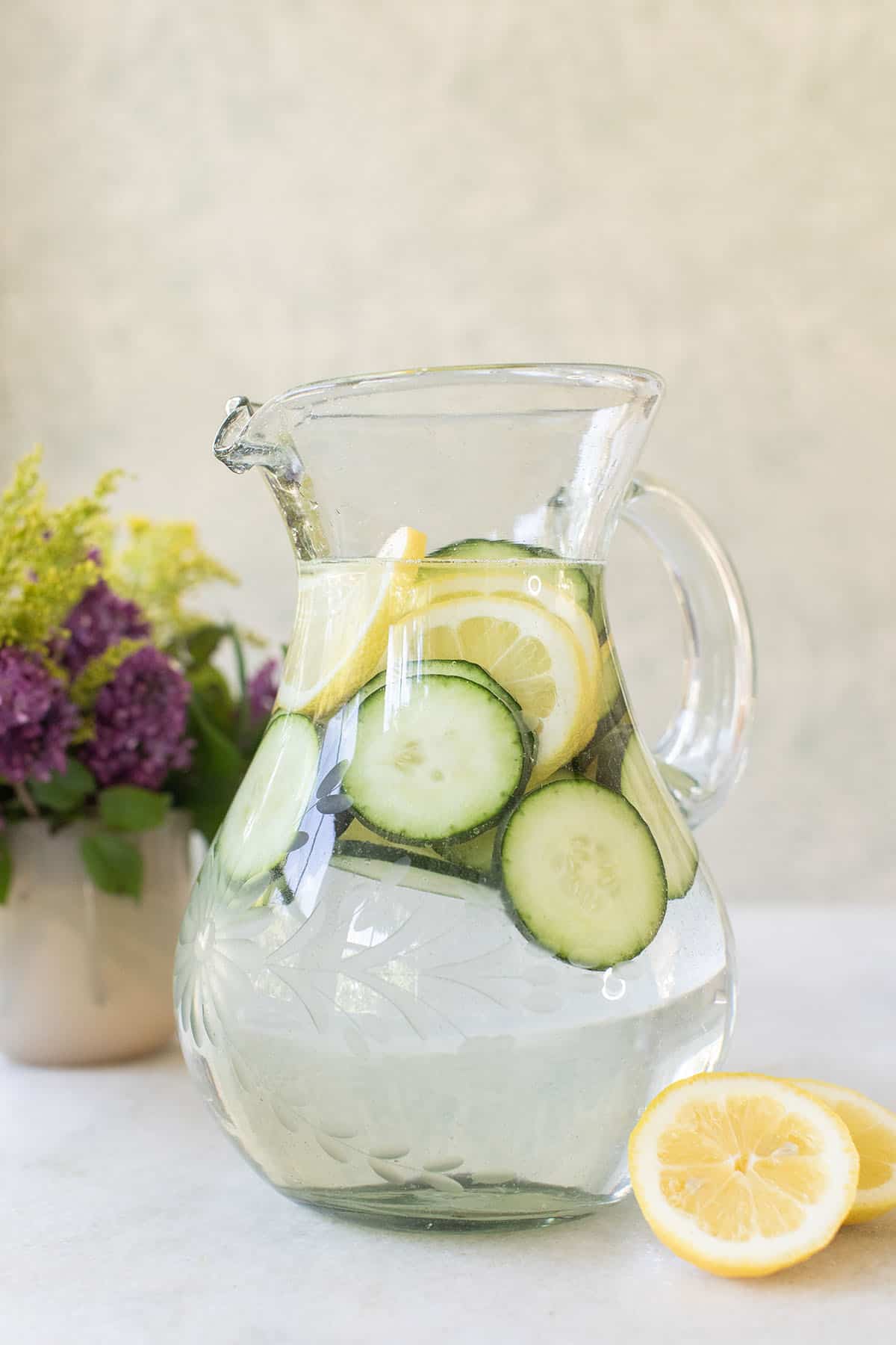 cucumber lemon water in a pitcher 