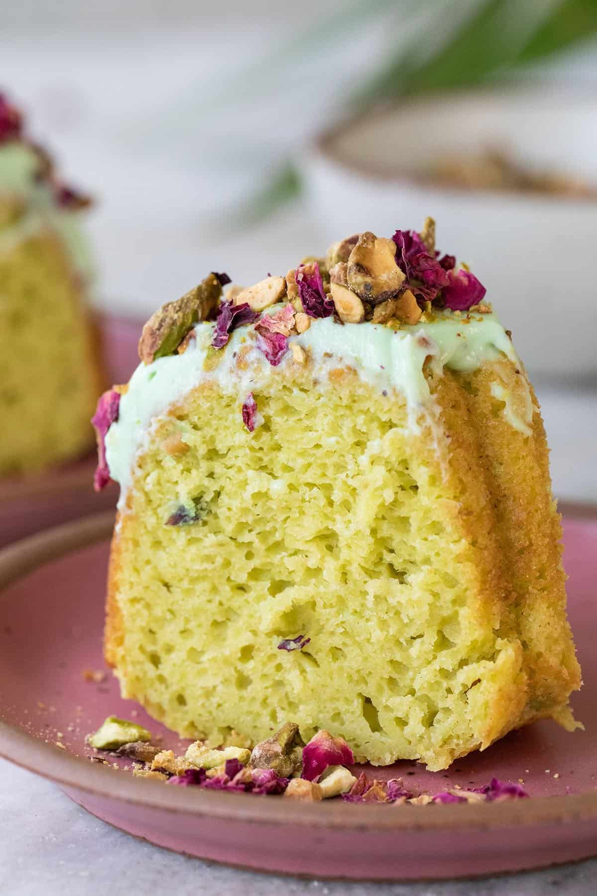 green pistachio cake with green frosting and dried flowers.