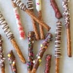 chocolate covered pretzel rods with sprinkles