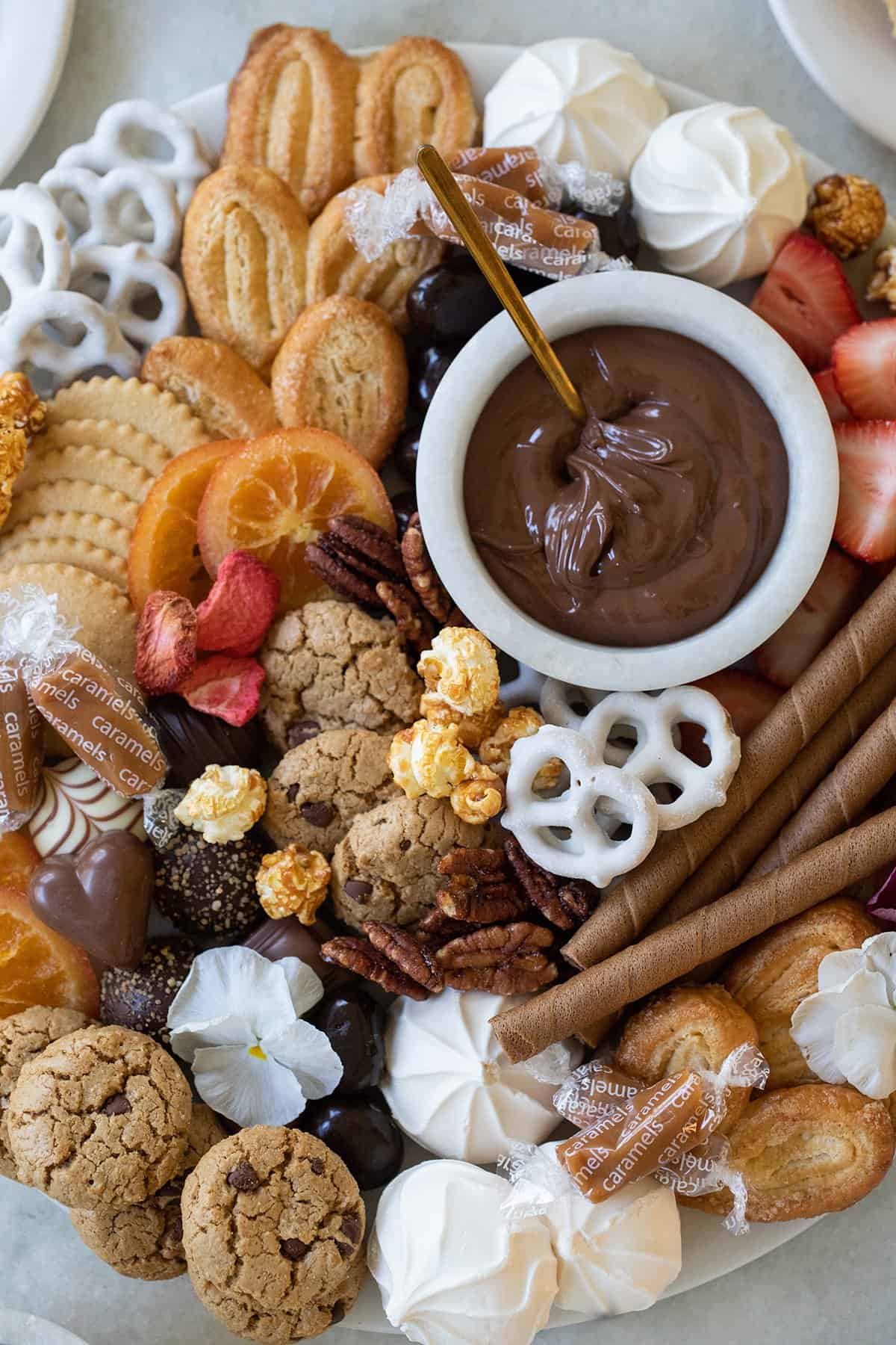 dessert board filled with candy and chocolate.