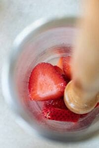 muddling strawberries