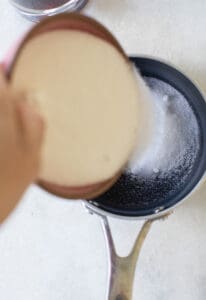 pouring sugar into a small pot