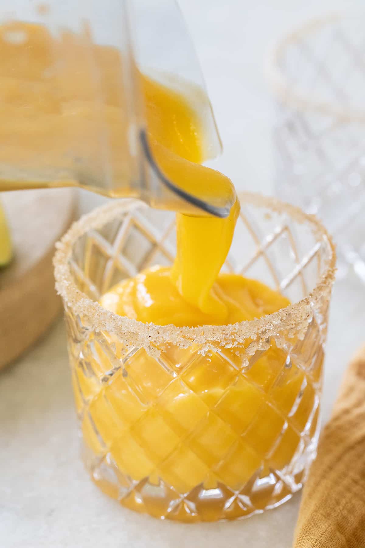 pouring a frozen cocktail into a glass