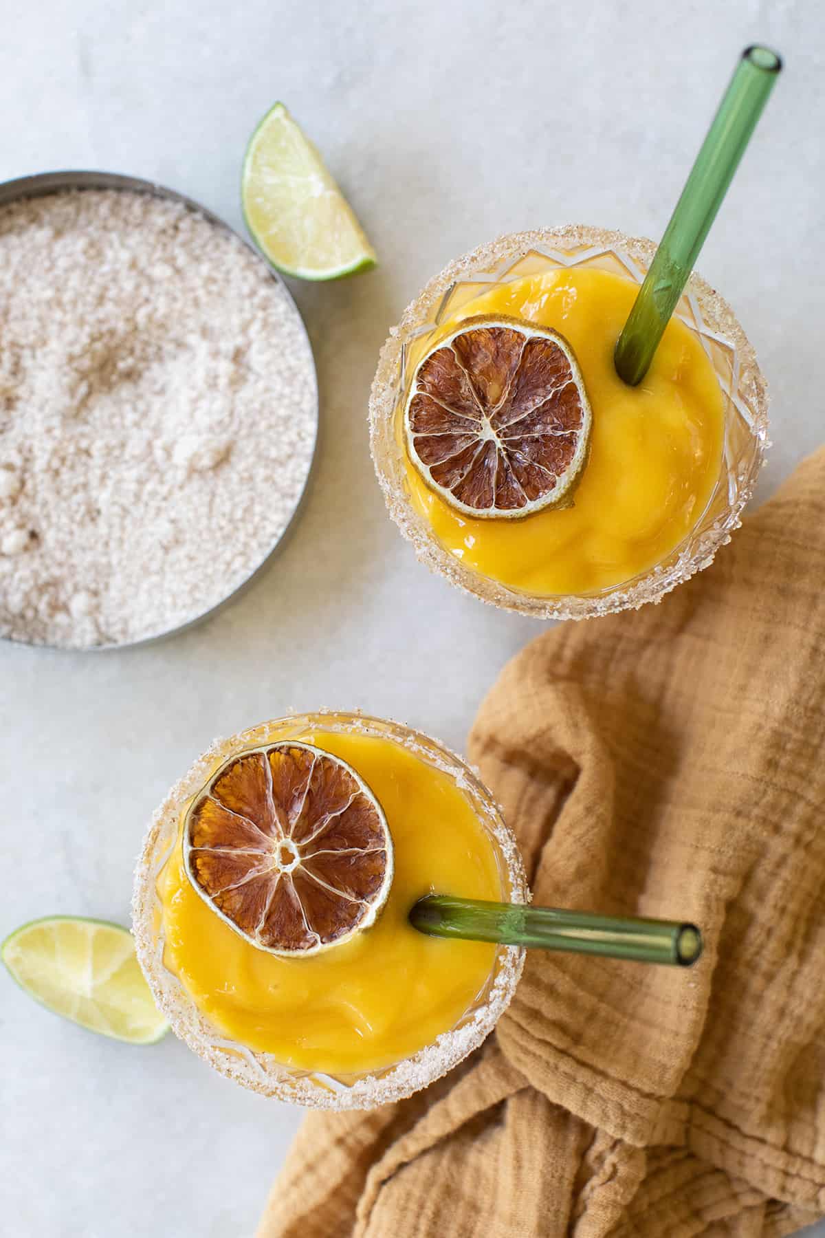 The best mango margaritas, frozen and perfect for summer with salt and lime slice. 