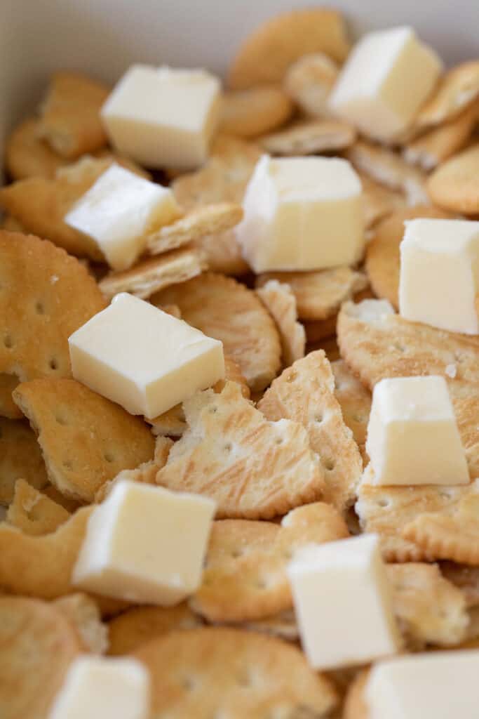 Crumbled Ritz crackers in a baking dish for oyster stuffing.