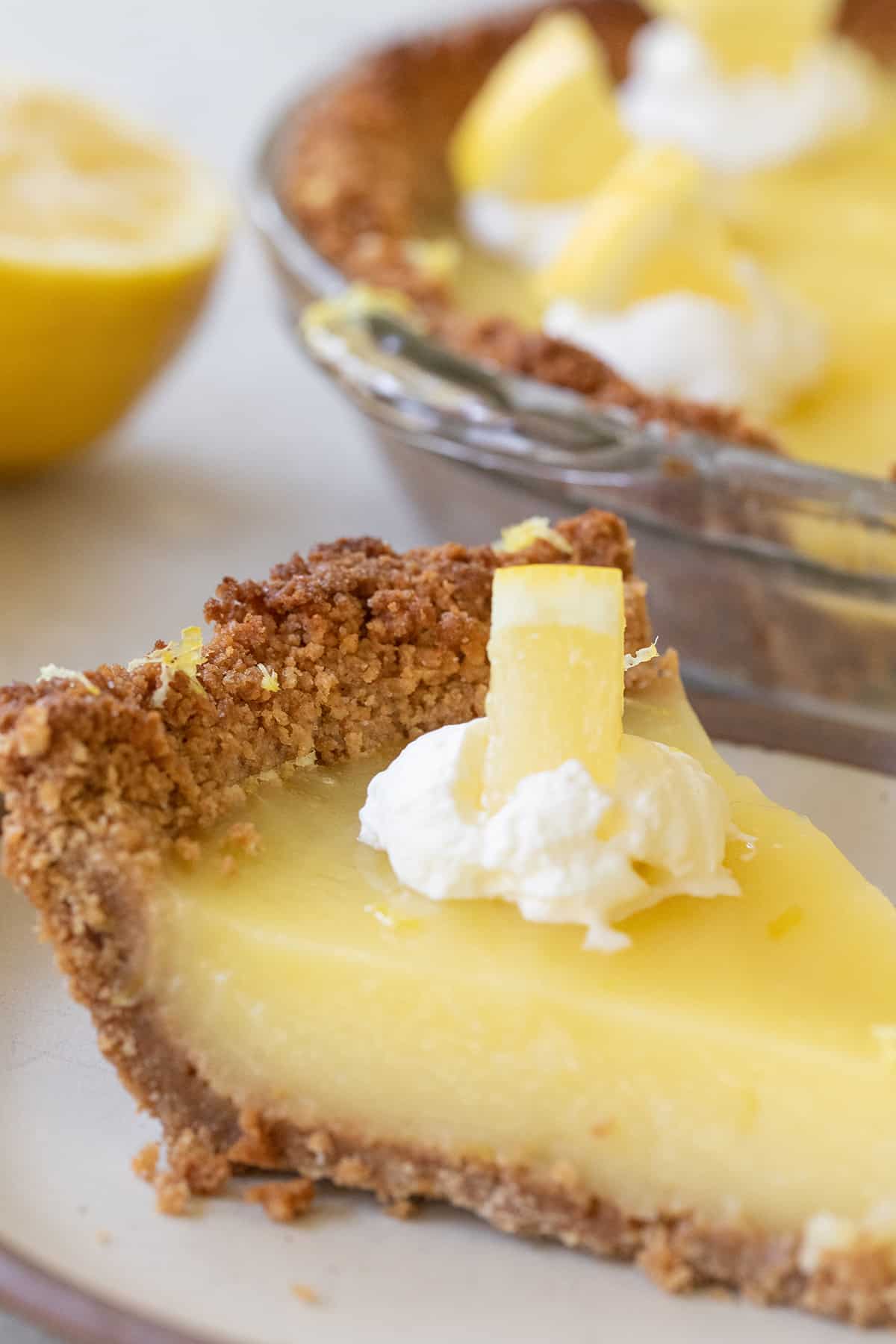 slice of a yellow fruit dessert with whipped cream 