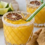 frozen mango margarita with a green straw