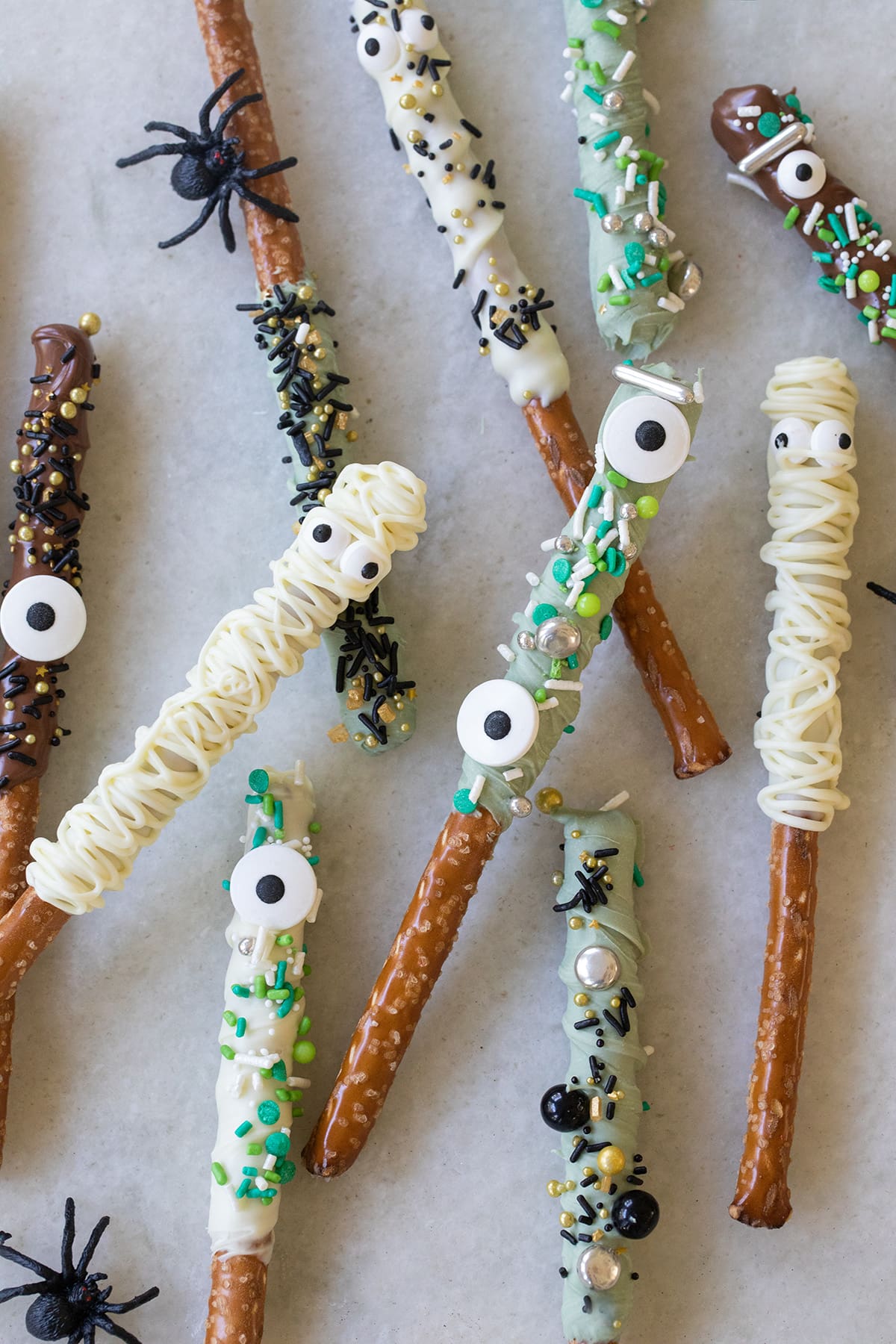 Halloween pretzel rods decorated as mummies, witches and monsters.