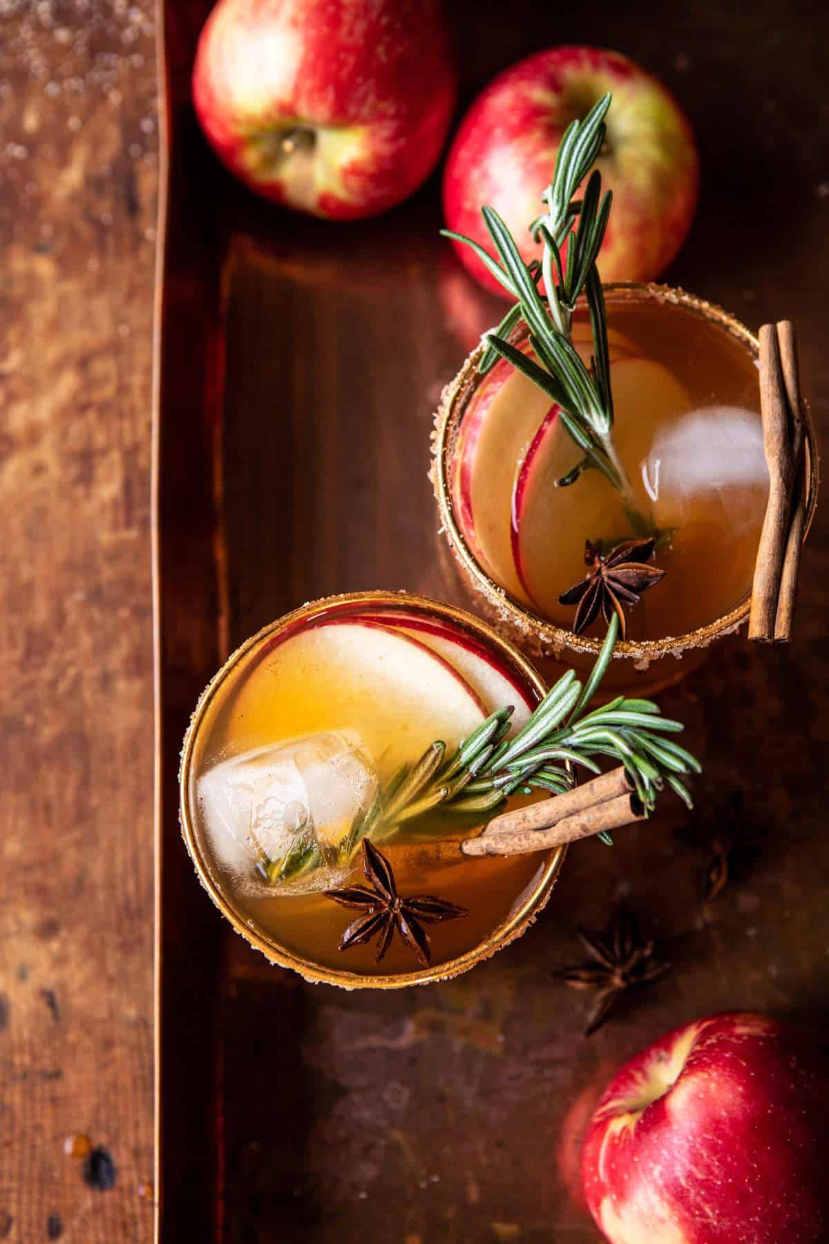 apple cider margarita with a cinnamon stick and rosemary.