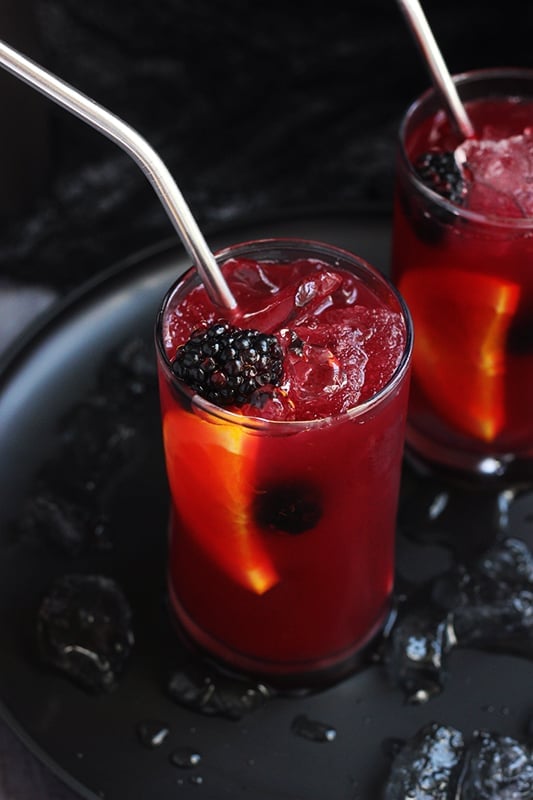 Dark red Halloween drink with fruit and blackberries. 