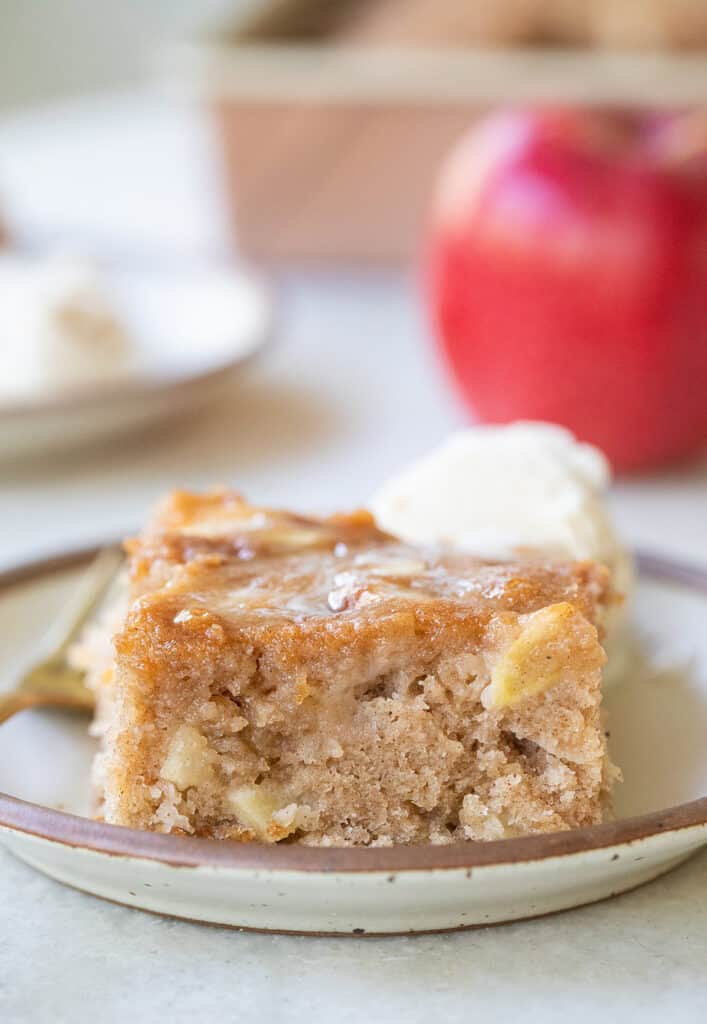 A slice of apple cake on a plate.