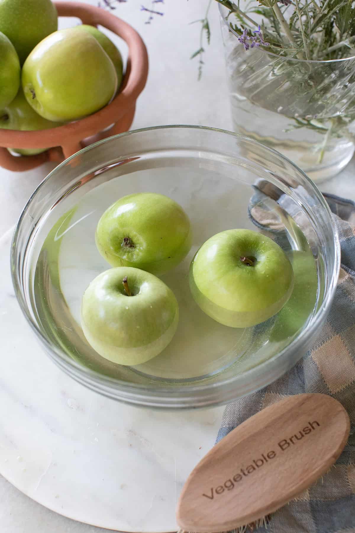 Removing wax from an apple to make candy apples.