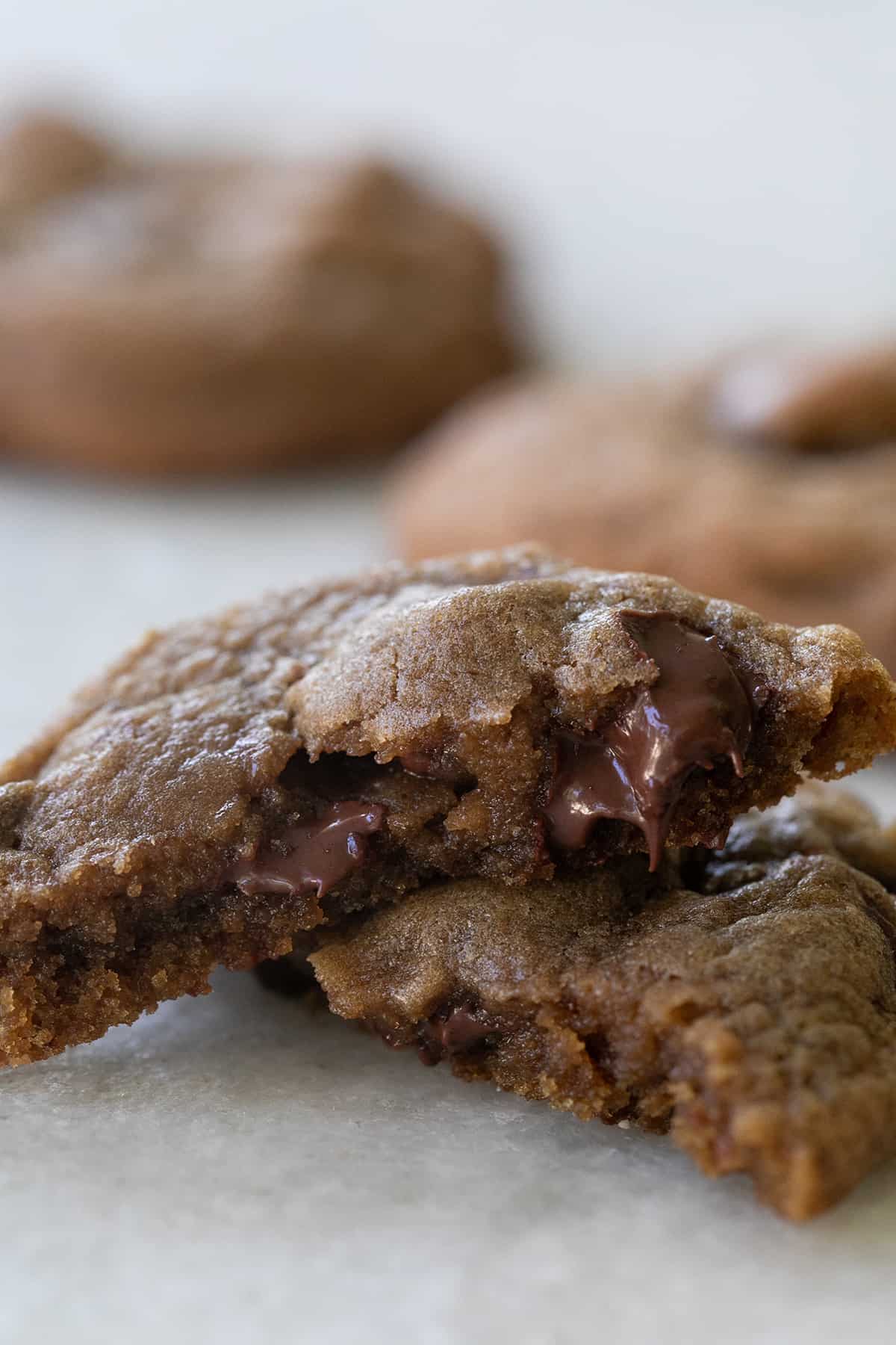 Chewy cookie broken in half with chocolate chips.