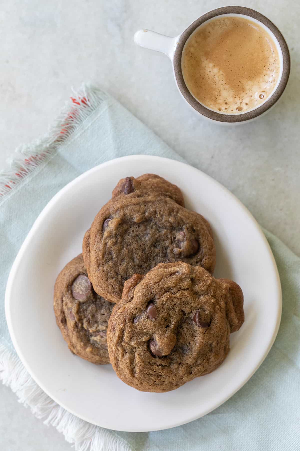 Espresso cookies on a white plate with a shot of espresso.