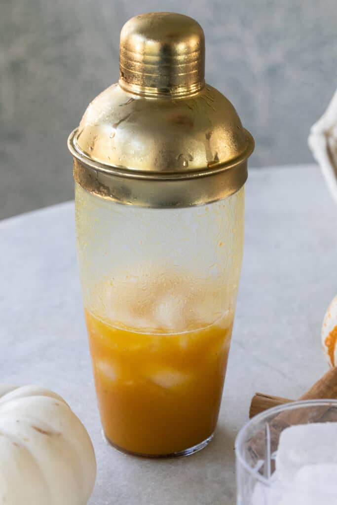 Orange cocktail in a shaker.