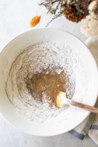Flour and apple batter in a mixing bowl.