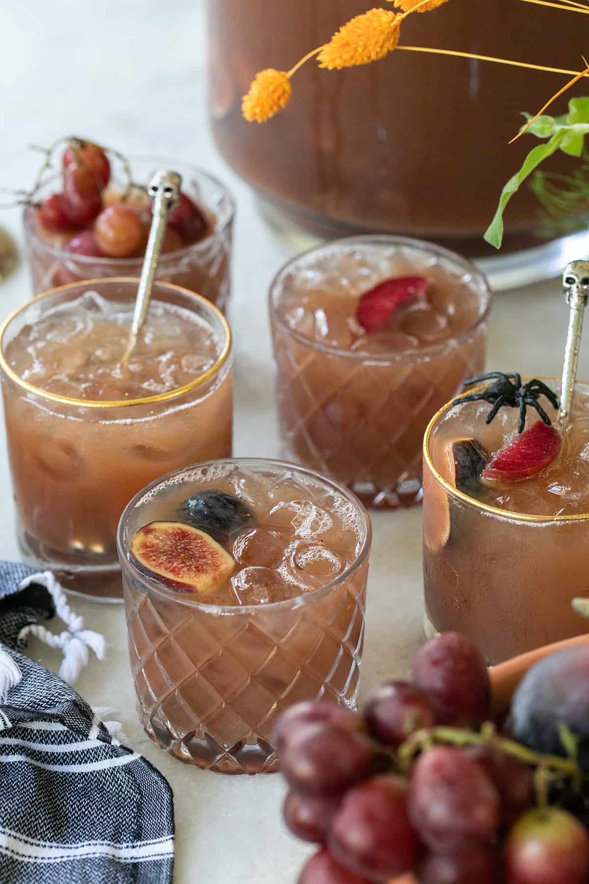 Halloween jungle juice in glasses with fruit.