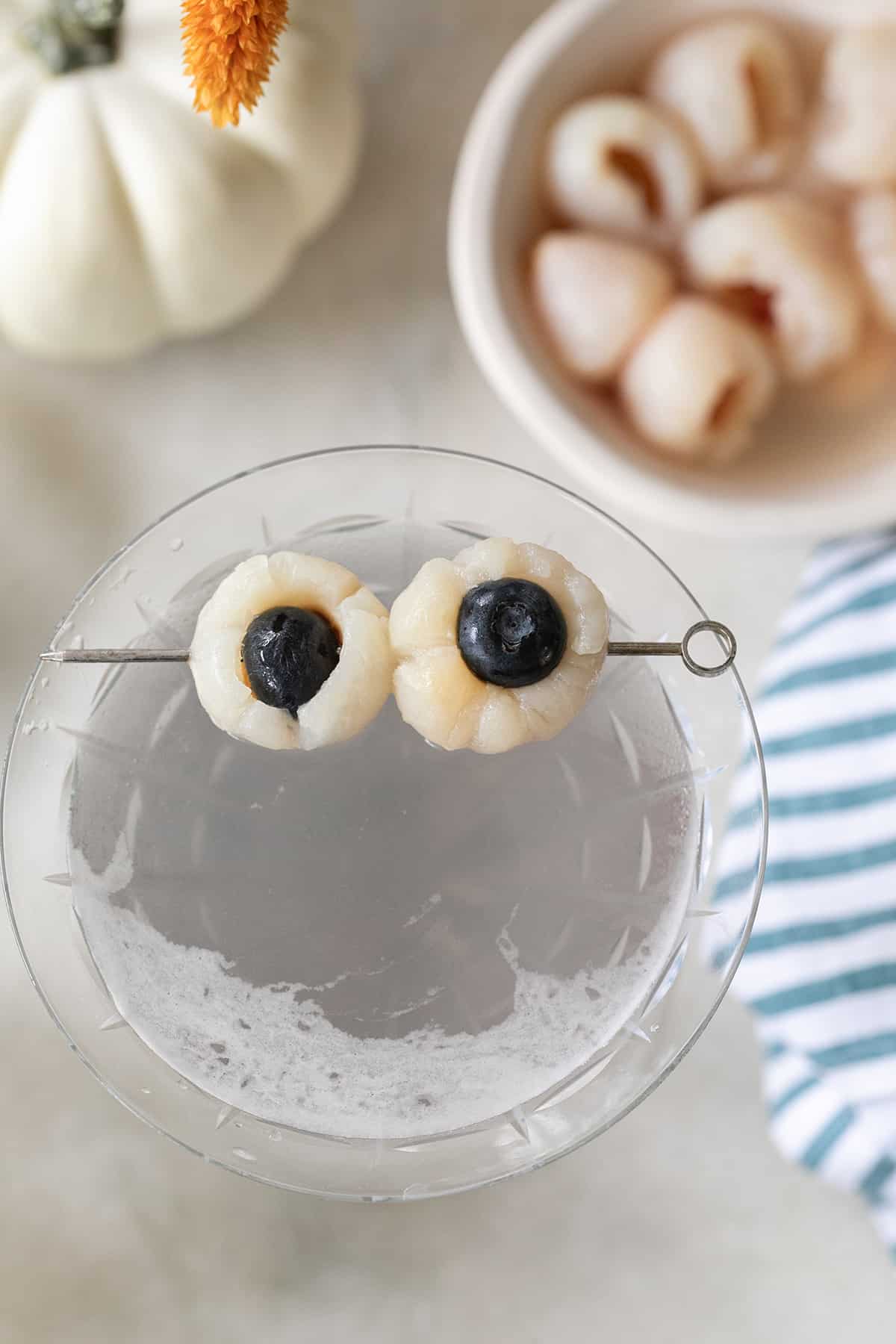 A Halloween lychee martini with spooky eyes.