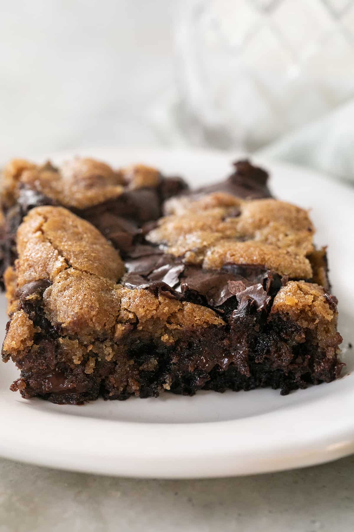 A brownie and a cookie baked together on a white plate.