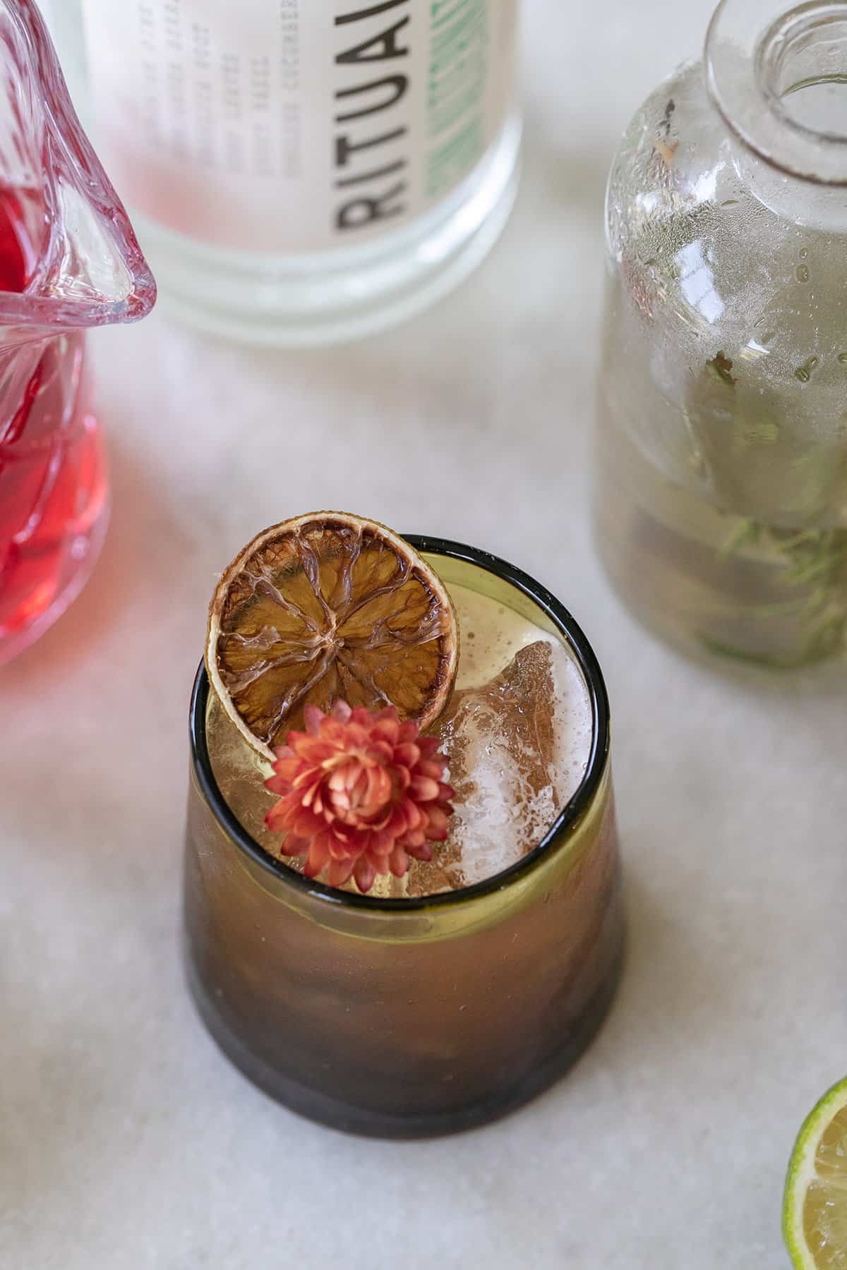 Thanksgiving mocktail in a glass with apple cider and cranberry.