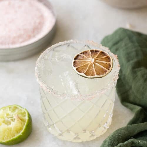 Margarita mocktail on a marble table with a green napkin.