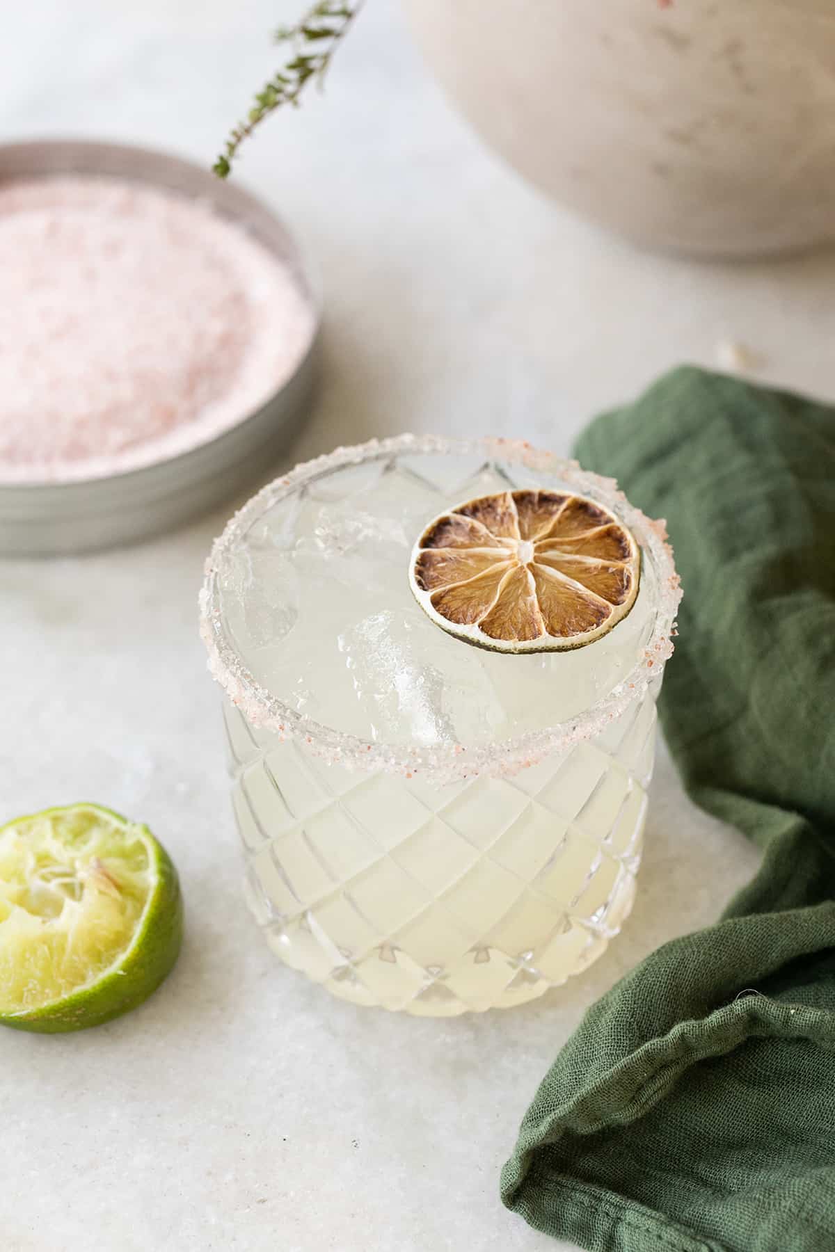 Margarita mocktail on a marble table with a green napkin.