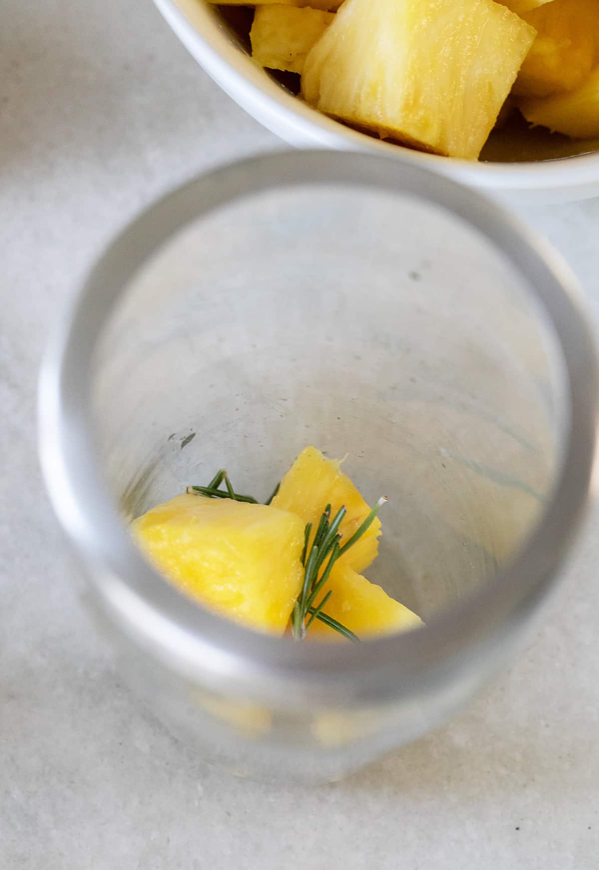 Pineapple chunks in a cocktail shaker. 