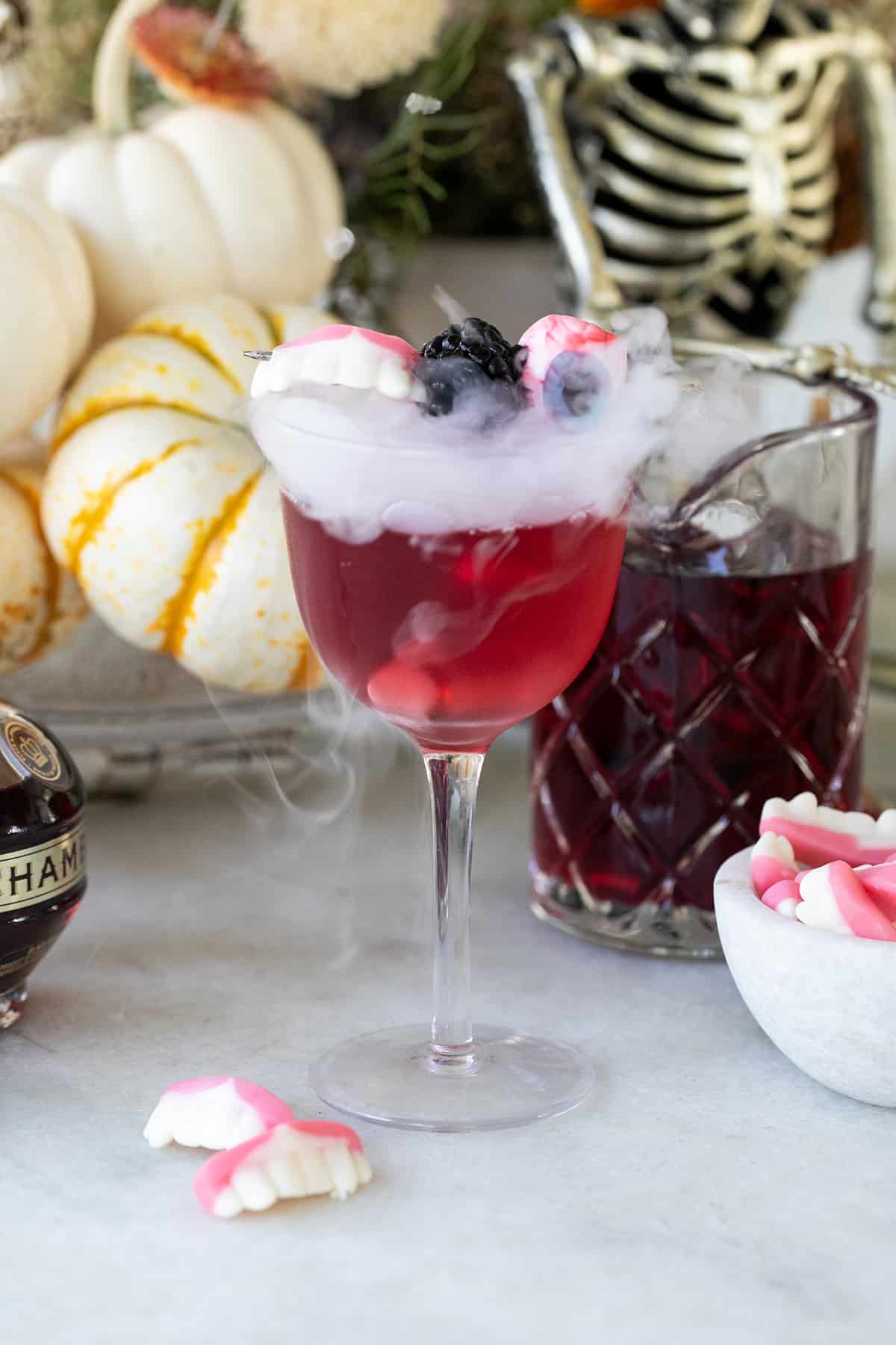 Halloween cocktail with dry ice and gummy eyes.