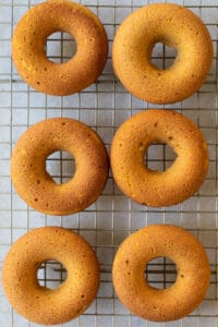 Baked pumpkin donuts without glaze on a cooling rack.