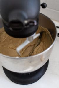 Sugar, eggs and butter in the bowl of a Kitchen Aid Mixer.