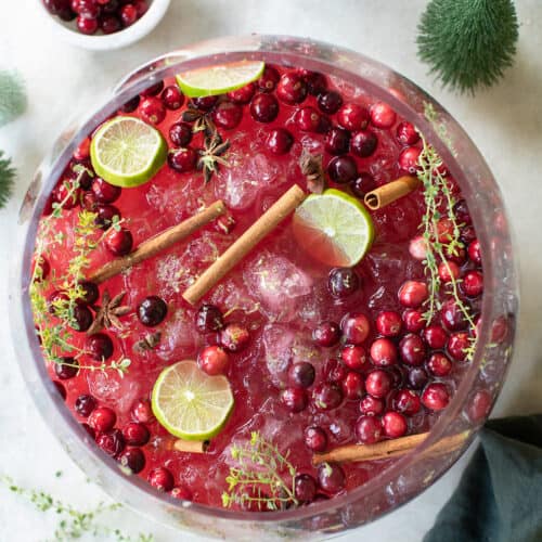 Christmas punch no alcohol with cinnamon sticks and lime slices.