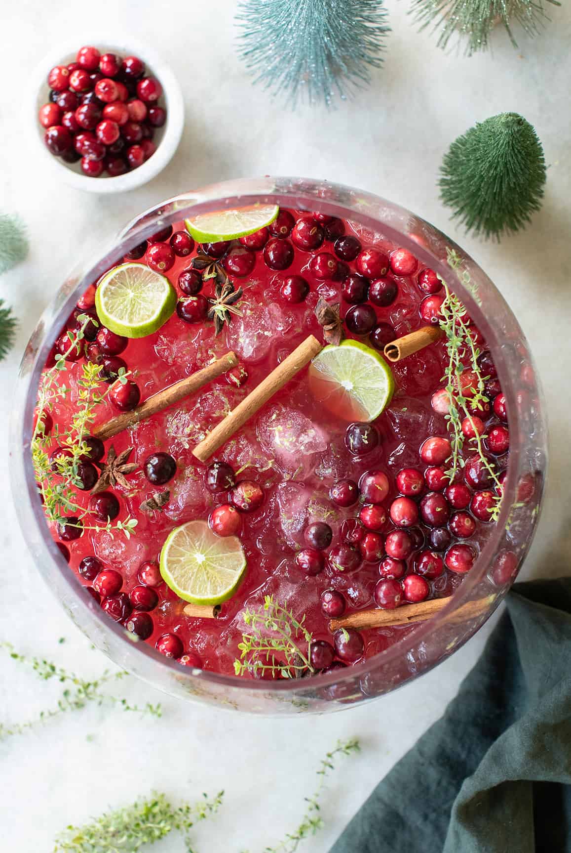 Christmas punch no alcohol with cinnamon sticks and lime slices.