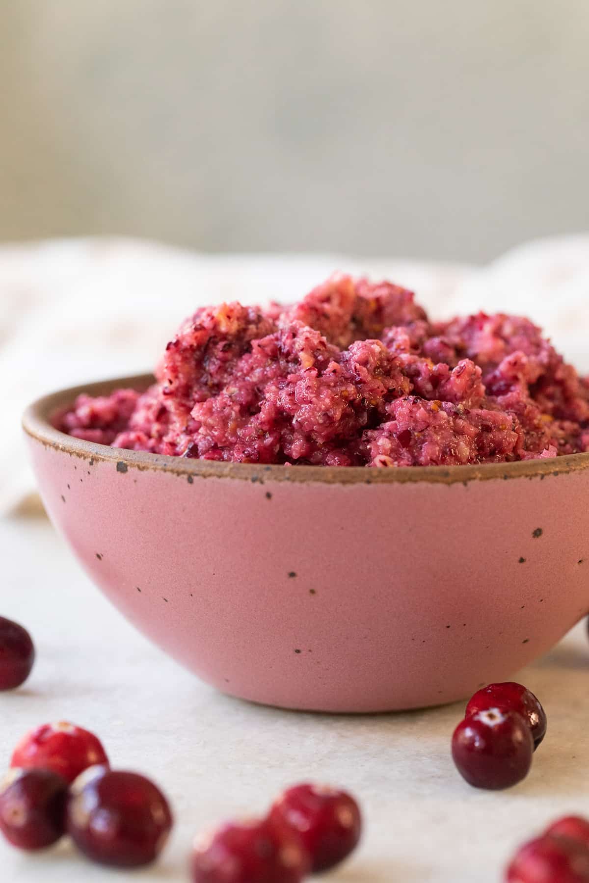 Cranberry orange relish in a pink bowl.