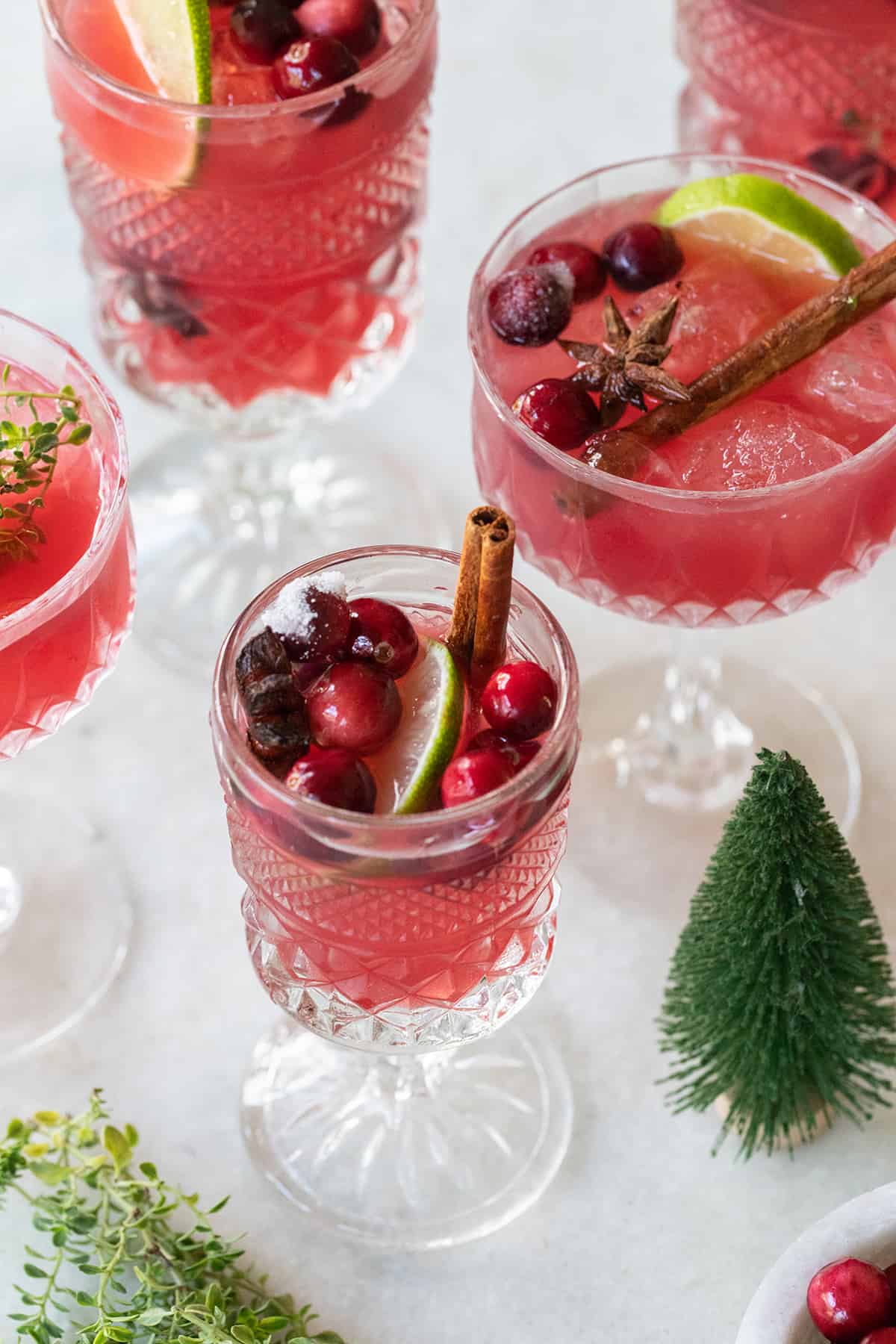 Mocktail with cranberry juice and cinnamon in vintage glasses.