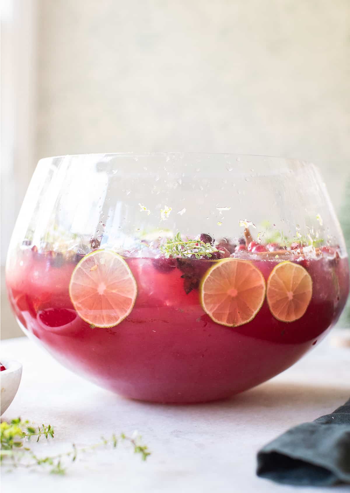 Red Christmas punch with lime slices.