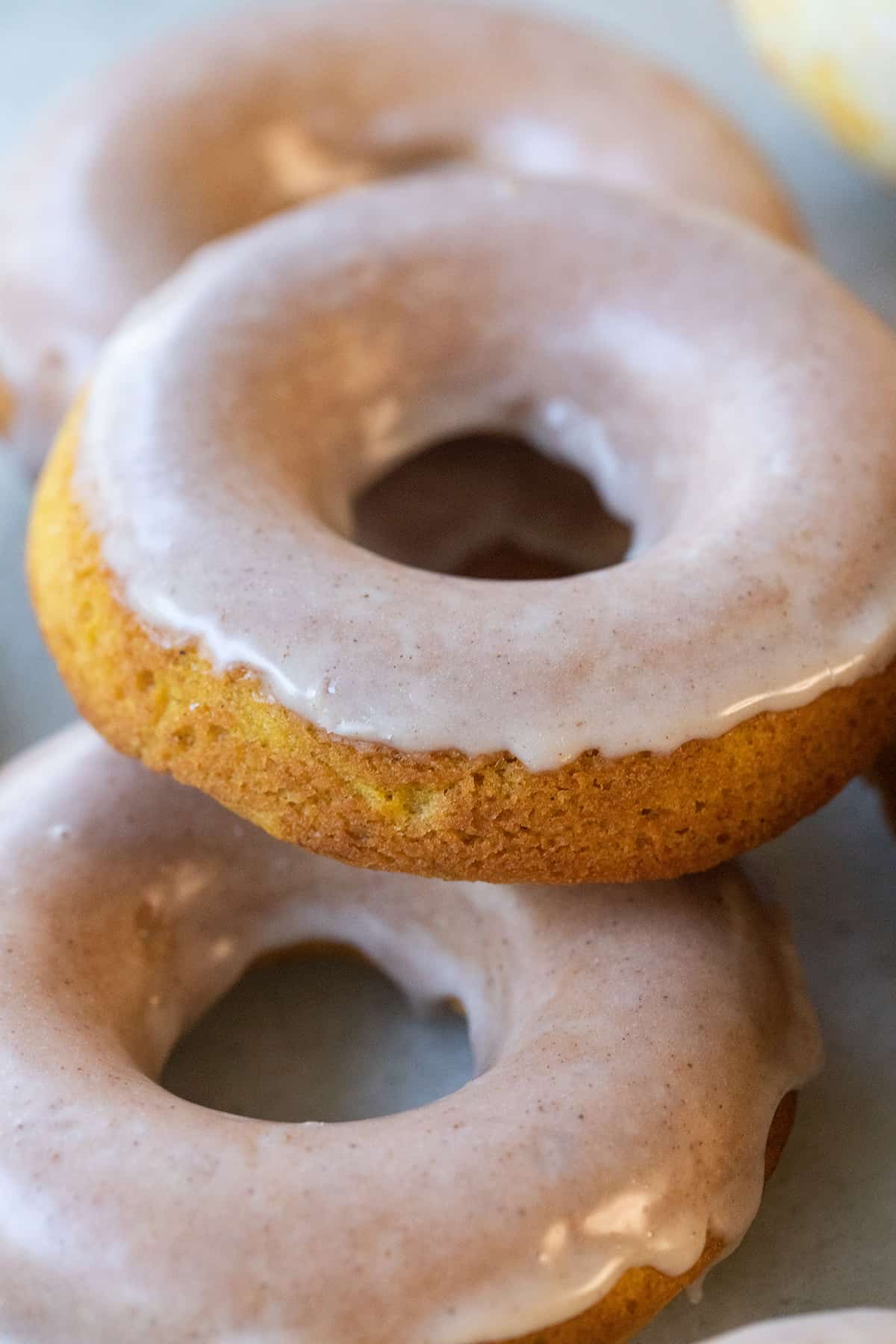 Baked pumpkin donuts stacked.