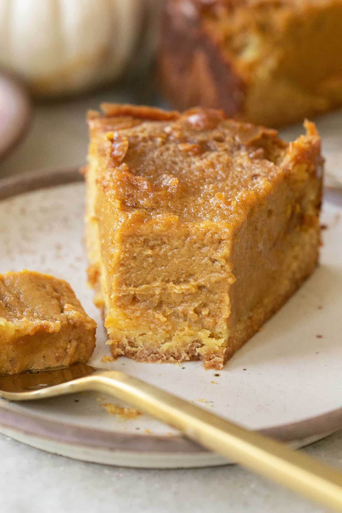 Gooey pumpkin butter cake with a slice taken out.