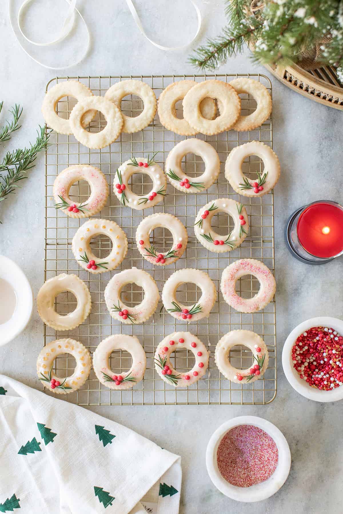 Christmas cookies shaped as wreaths on a cookie wrack.
