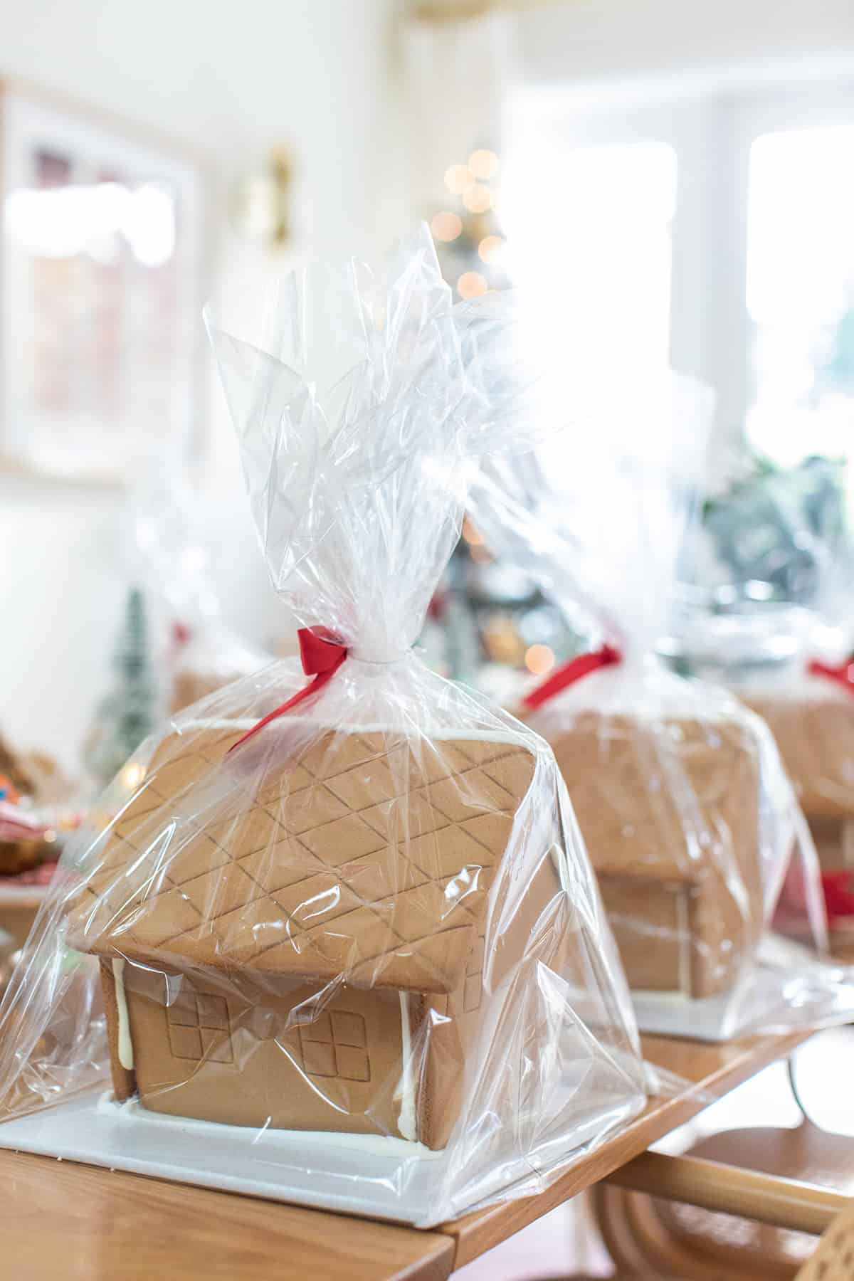 Gingerbread house kits wrapped on a table.