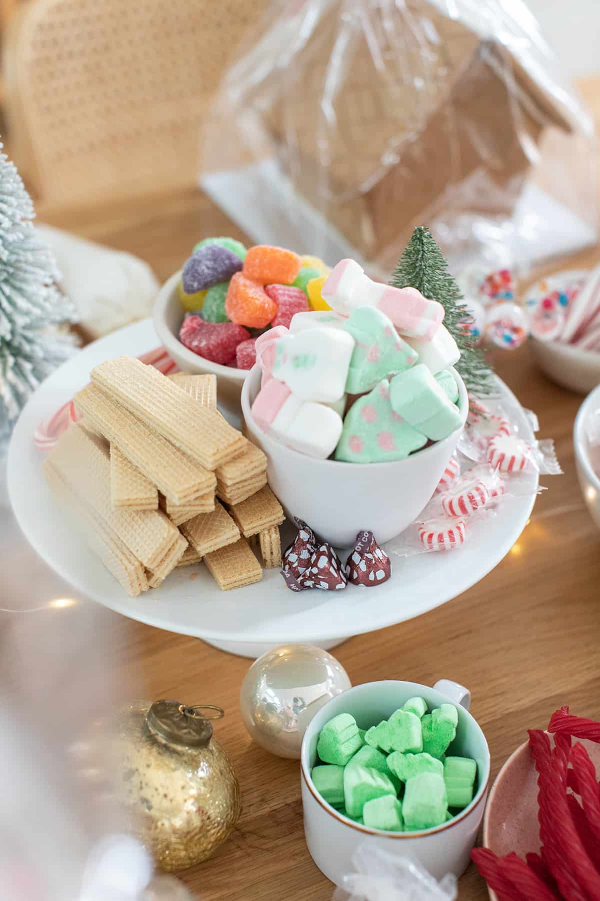 Bowls filled with Christmas candy candy to add to a gingerbread house.