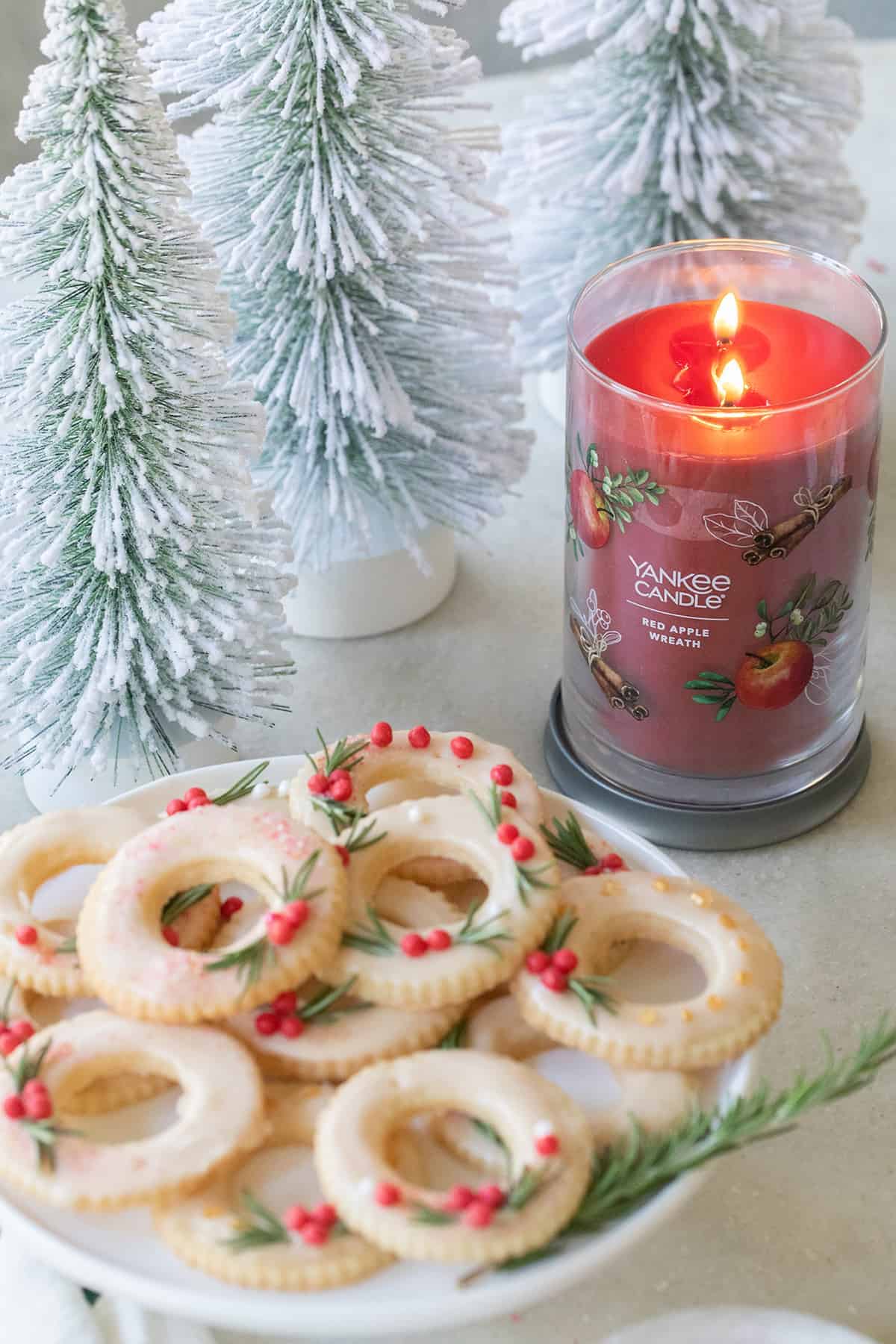 Cookies on a platter next to a Yankee Candle.